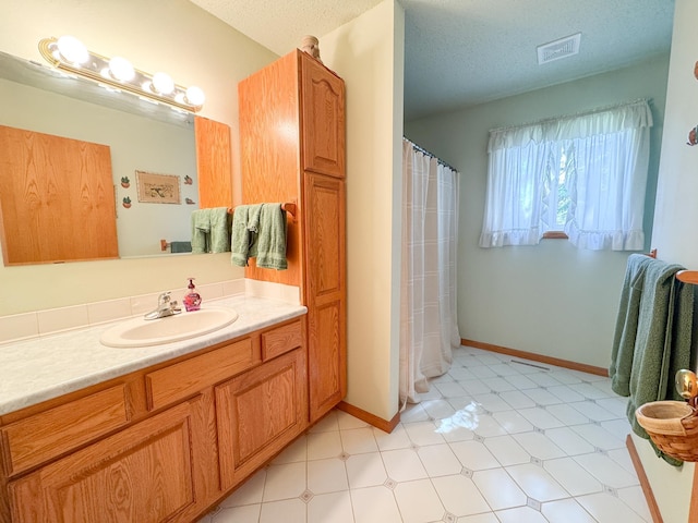 915 Stanton Ave, Fergus Falls, MN 56537 - full bathroom with vanity, a textured ceiling, and a shower with shower curtain