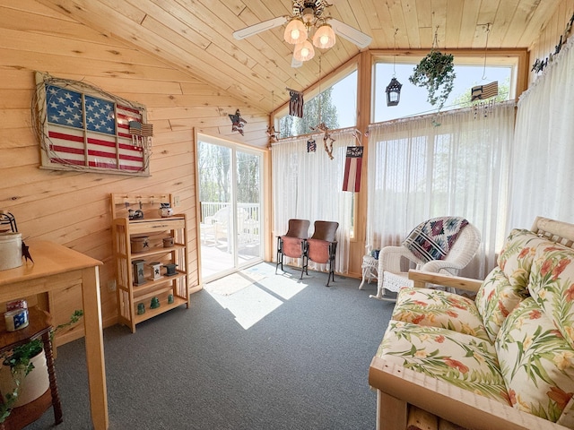 915 Stanton Ave, Fergus Falls, MN 56537 - carpeted living area with lofted ceiling, wood ceiling, wood walls, and a ceiling fan