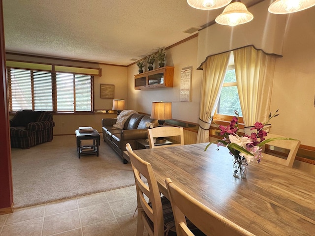8180 Diane St, Circle Pines, MN 55014 - dining room with carpet floors, a textured ceiling, tile patterned floors, and ornamental molding