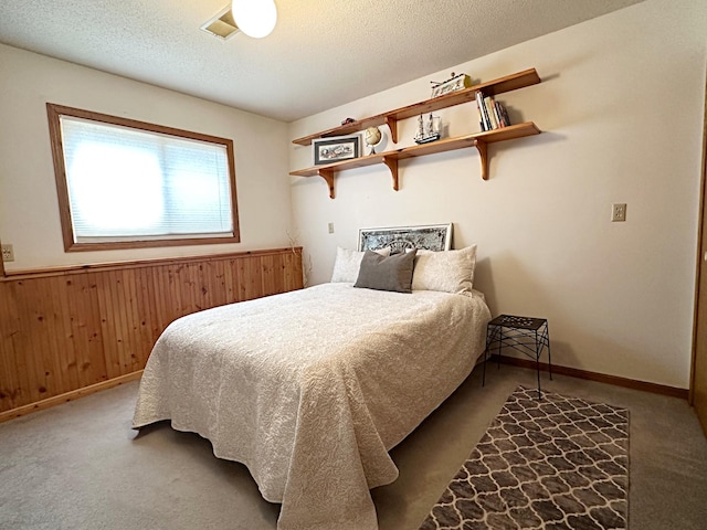 8180 Diane St, Circle Pines, MN 55014 - carpeted bedroom with wooden walls and a textured ceiling