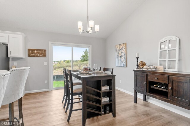 1013 2nd St NW, Delano, MN 55328 - dining area with a chandelier, light wood-style flooring, and lofted ceiling