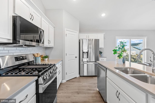 1013 2nd St NW, Delano, MN 55328 - kitchen featuring stainless steel appliances, light countertops, white cabinetry, and recessed lighting