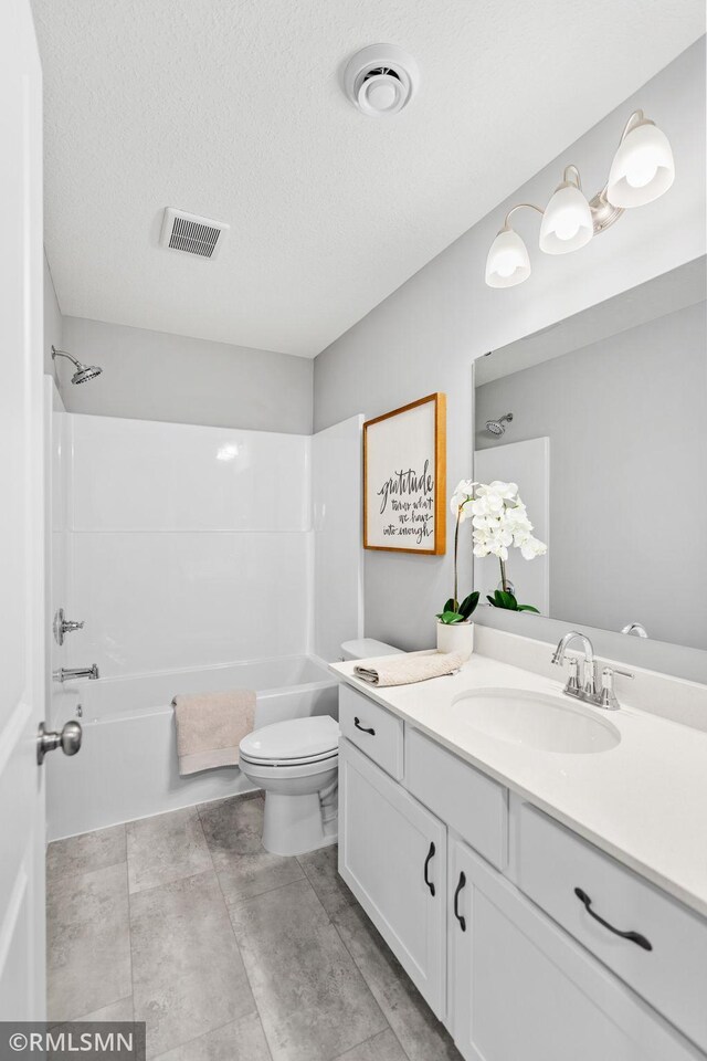 1013 2nd St NW, Delano, MN 55328 - bathroom with vanity,  shower combination, and a textured ceiling