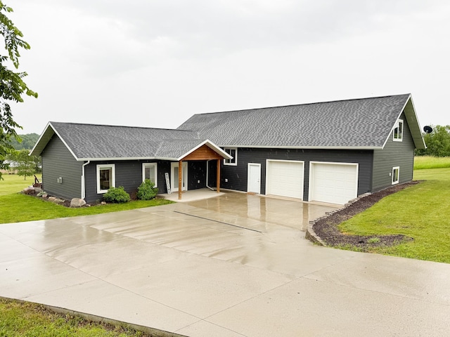24718 Elbow Rd, Pelican Rapids, MN 56572 - view of front of home featuring a front yard, driveway, roof with shingles, and a garage