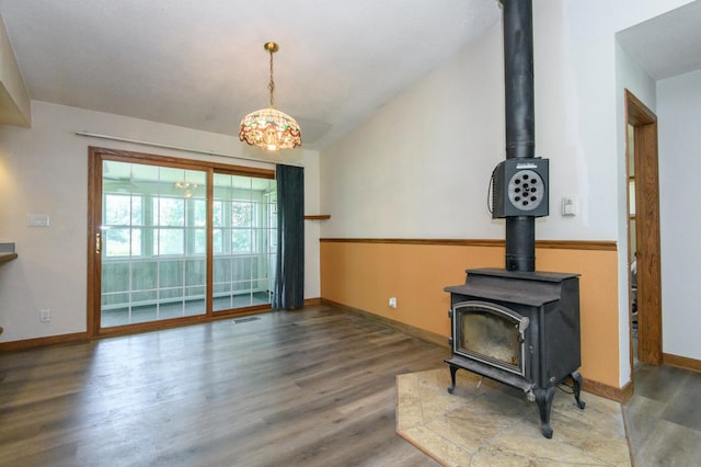 W224S9735 Big Bend Dr, Vernon, WI 53103 - living area with a wood stove, wood finished floors, and lofted ceiling
