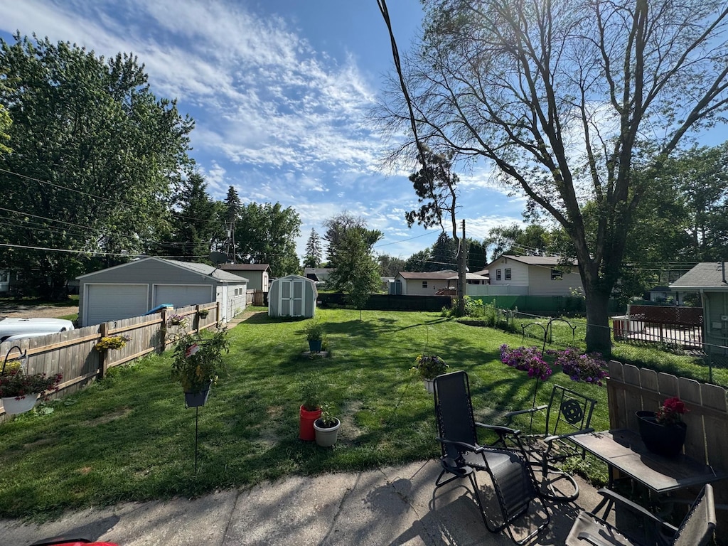 176 8th Ave NE, Forest Lake, MN 55025 - fenced yard featuring a garage and a shed