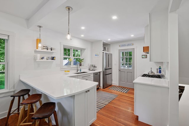 3815 Deephaven Ave, Deephaven, MN 55391 - kitchen with open shelves, appliances with stainless steel finishes, a breakfast bar area, healthy amount of natural light, and recessed lighting