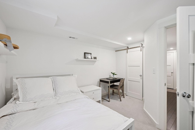 3815 Deephaven Ave, Deephaven, MN 55391 - bedroom with a barn door, light colored carpet, and recessed lighting