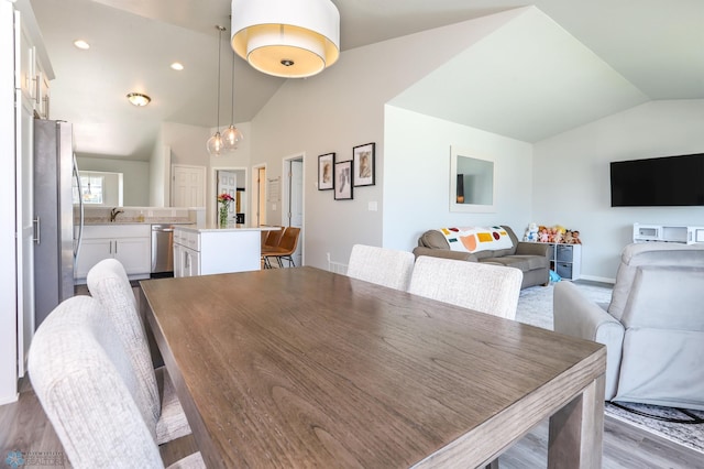 6870 17th St S, Fargo, ND 58104 - dining space featuring lofted ceiling, wood finished floors, and recessed lighting