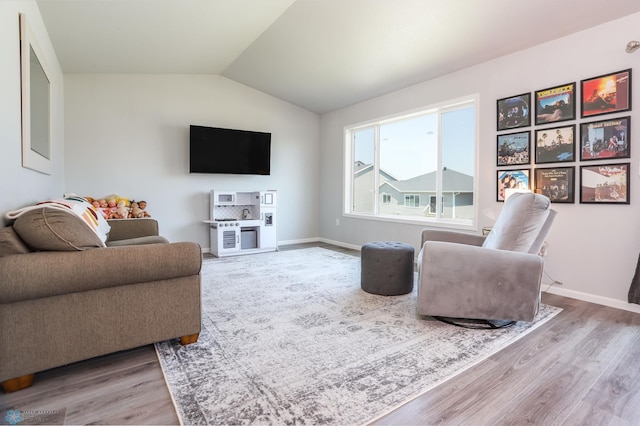 6870 17th St S, Fargo, ND 58104 - living area with wood finished floors and vaulted ceiling
