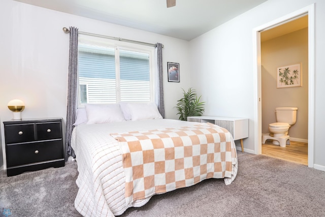 6870 17th St S, Fargo, ND 58104 - carpeted bedroom with radiator, connected bathroom, and a ceiling fan