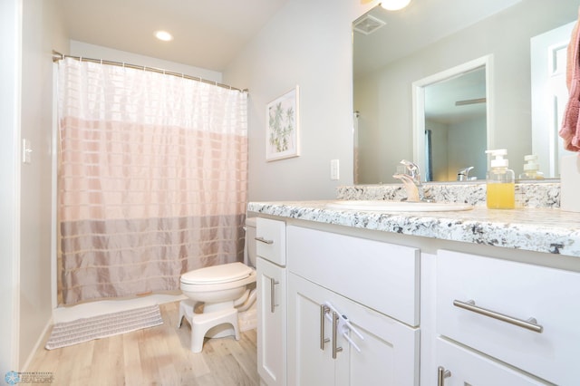 6870 17th St S, Fargo, ND 58104 - full bathroom with wood finished floors, vanity, curtained shower, and recessed lighting