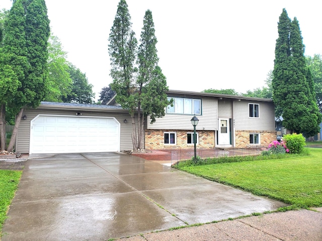 8921 49th Ave N, New Hope, MN 55428 - raised ranch featuring a garage, a front lawn, and driveway