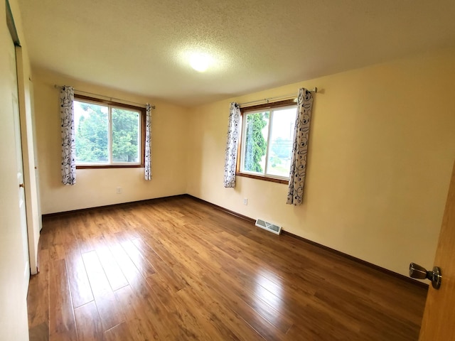 8921 49th Ave N, New Hope, MN 55428 - spare room featuring wood finished floors and a textured ceiling