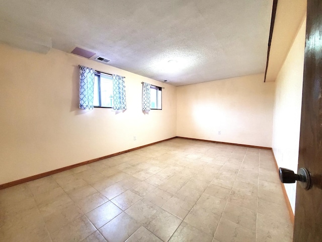 8921 49th Ave N, New Hope, MN 55428 - spare room featuring a textured ceiling and baseboards