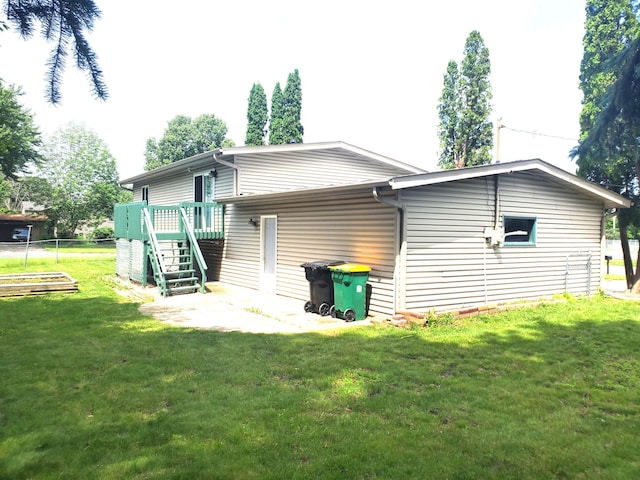 8921 49th Ave N, New Hope, MN 55428 - back of house with stairs, a lawn, and a deck