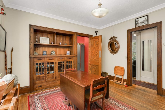 1914 Grand Ave, Saint Paul, MN 55105 - dining space featuring wood finished floors, ornamental molding, and a textured ceiling