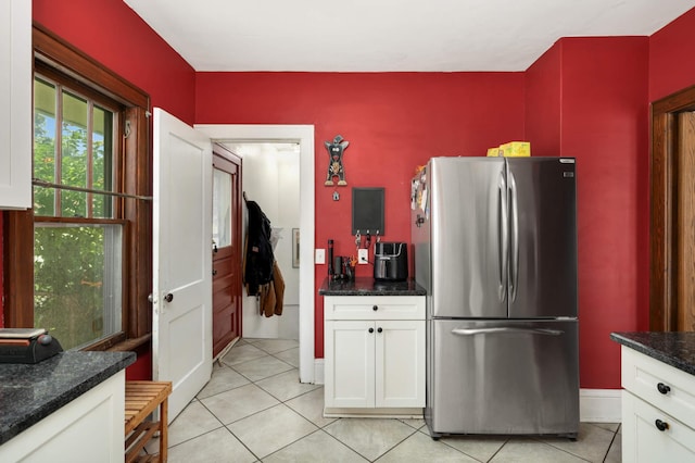 1914 Grand Ave, Saint Paul, MN 55105 - kitchen with freestanding refrigerator, light tile patterned flooring, white cabinets, and dark stone countertops