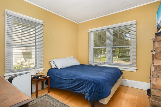 1914 Grand Ave, Saint Paul, MN 55105 - bedroom featuring crown molding, wood finished floors, and multiple windows