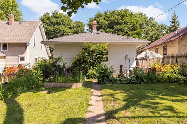 1914 Grand Ave, Saint Paul, MN 55105 - rear view of house featuring a garden and a chimney