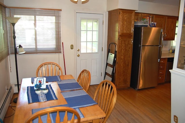 1445 Ottawa Ave S, Golden Valley, MN 55416 - dining space with light wood finished floors and a baseboard radiator