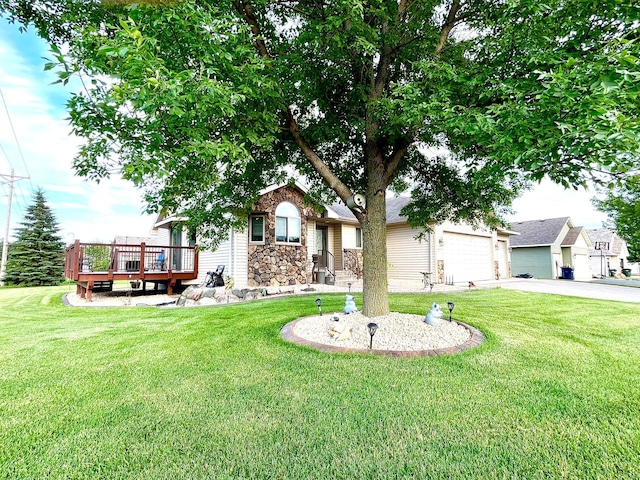 24482 18th Ave, Saint Augusta, MN 56301 - view of front facade with driveway, a front yard, stone siding, a wooden deck, and an attached garage