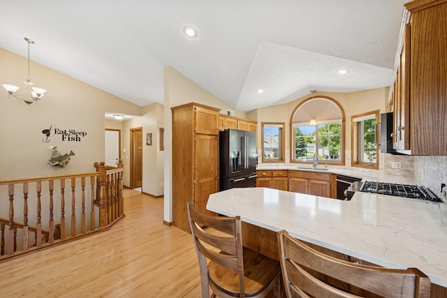 24482 18th Ave, Saint Augusta, MN 56301 - kitchen with refrigerator with ice dispenser, lofted ceiling, dishwasher, a peninsula, and light wood-style flooring