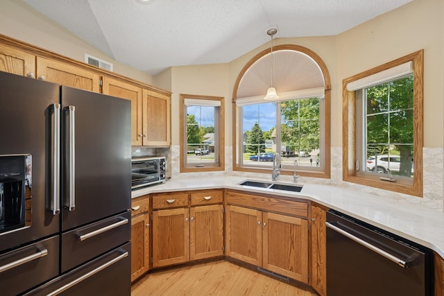 24482 18th Ave, Saint Augusta, MN 56301 - kitchen with fridge with ice dispenser, black dishwasher, light countertops, lofted ceiling, and light wood finished floors