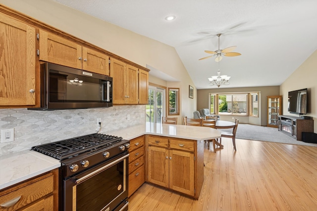 24482 18th Ave, Saint Augusta, MN 56301 - kitchen featuring black appliances, a peninsula, lofted ceiling, light wood-style flooring, and backsplash