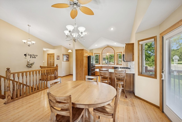 24482 18th Ave, Saint Augusta, MN 56301 - dining space featuring light wood finished floors, a chandelier, vaulted ceiling, healthy amount of natural light, and ceiling fan