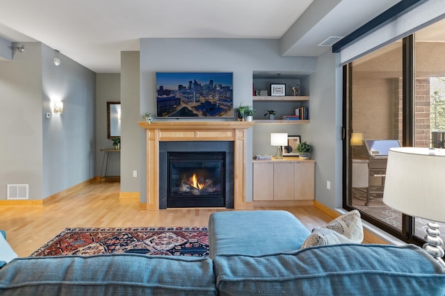 317 Groveland Ave Unit 106, Minneapolis, MN 55403 - living area with wood finished floors and a glass covered fireplace