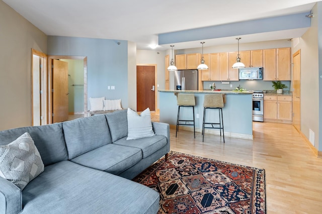 317 Groveland Ave Unit 106, Minneapolis, MN 55403 - living area with light wood-style flooring and baseboards