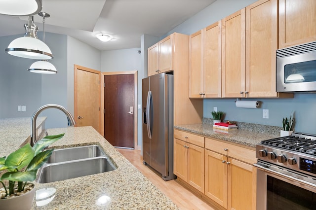 317 Groveland Ave Unit 106, Minneapolis, MN 55403 - kitchen with appliances with stainless steel finishes, light wood-style floors, light brown cabinets, and light stone counters
