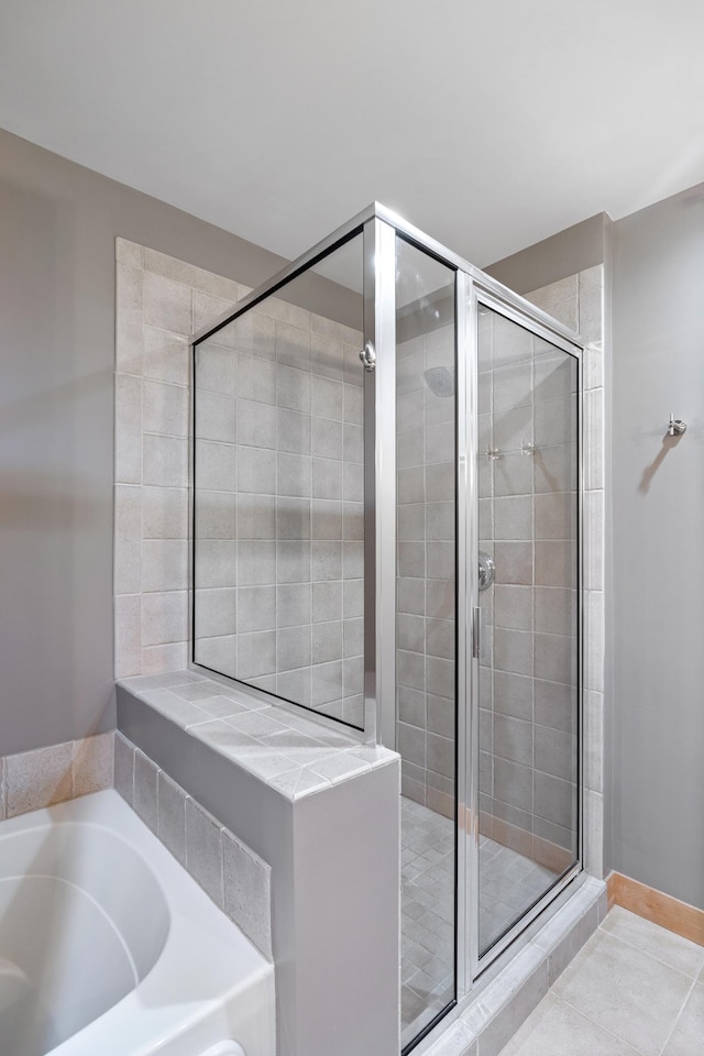 317 Groveland Ave Unit 106, Minneapolis, MN 55403 - bathroom featuring a stall shower, a garden tub, and tile patterned flooring