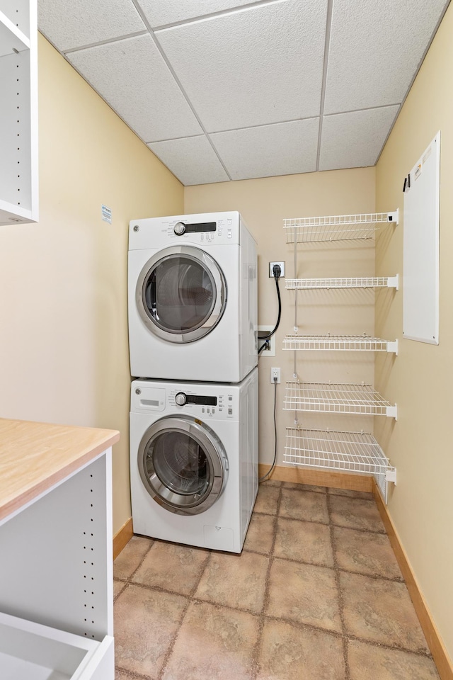 317 Groveland Ave Unit 106, Minneapolis, MN 55403 - laundry room featuring stacked washer / drying machine and baseboards