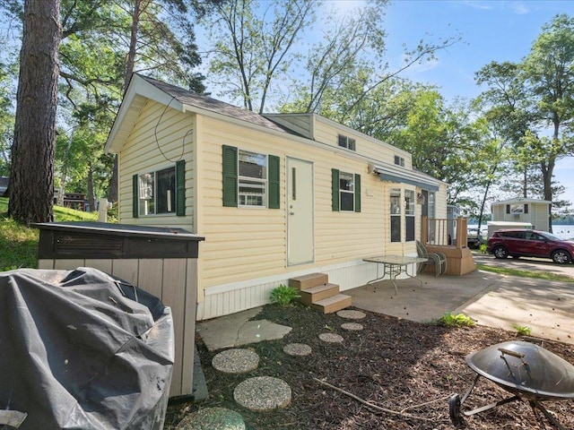 15827 Wilderness Trl Unit 30, Crosslake, MN 56442 - view of home's exterior with entry steps and a patio area