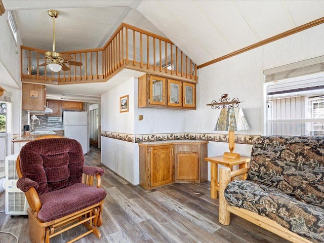 15827 Wilderness Trl Unit 30, Crosslake, MN 56442 - living room featuring wood finished floors, ceiling fan, ornamental molding, a wainscoted wall, and high vaulted ceiling