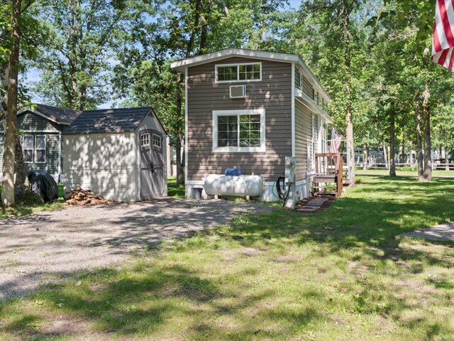 15827 Wilderness Trl Unit 112, Crosslake, MN 56442 - view of front of property with a shed and a front yard
