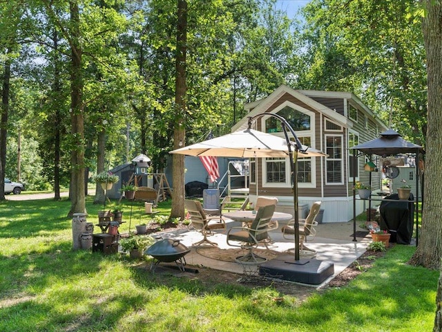 15827 Wilderness Trl Unit 112, Crosslake, MN 56442 - rear view of property featuring a yard and a patio area