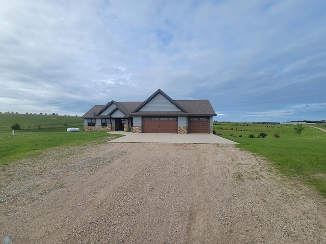 11003 Eagles Nest Ct, Audubon, MN 56511 - view of front of house with stone siding, driveway, an attached garage, a view of rural / pastoral area, and a front lawn