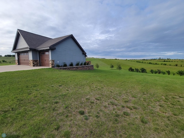 11003 Eagles Nest Ct, Audubon, MN 56511 - view of property exterior with concrete driveway, a lawn, an attached garage, a shingled roof, and a view of rural / pastoral area
