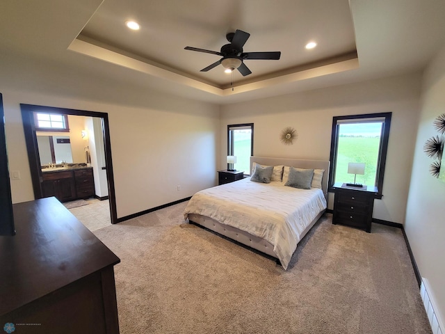 11003 Eagles Nest Ct, Audubon, MN 56511 - bedroom with light colored carpet, a tray ceiling, recessed lighting, ceiling fan, and ensuite bathroom