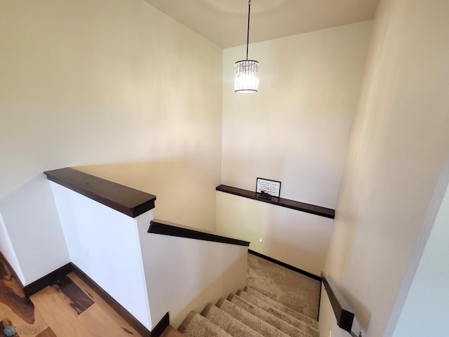 11003 Eagles Nest Ct, Audubon, MN 56511 - stairway featuring baseboards and a chandelier