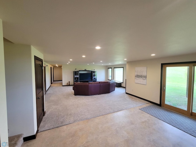 11003 Eagles Nest Ct, Audubon, MN 56511 - living area featuring light colored carpet, recessed lighting, and concrete flooring