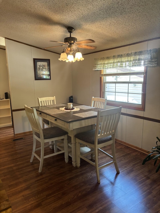 77165 Stepan Rd, Kettle River Twp, MN 55795 - dining room featuring dark wood-style flooring, a textured ceiling, and a ceiling fan