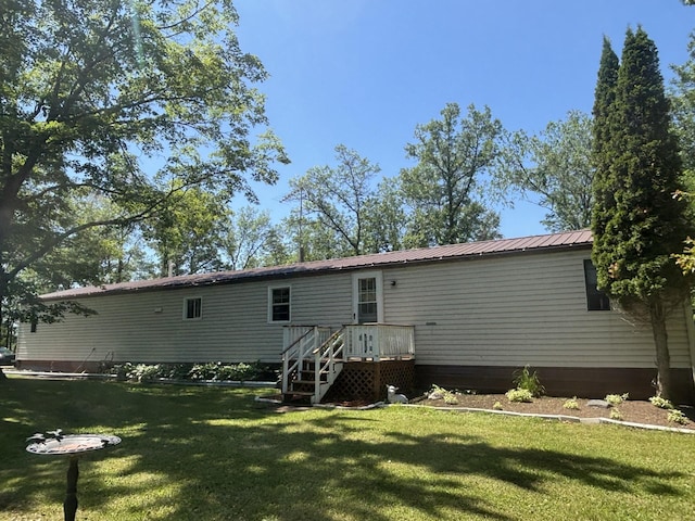 77165 Stepan Rd, Kettle River Twp, MN 55795 - back of property with a lawn and a metal roof