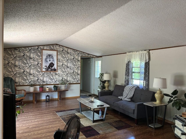 77165 Stepan Rd, Kettle River Twp, MN 55795 - living area featuring wood finished floors, wallpapered walls, vaulted ceiling, and a textured ceiling