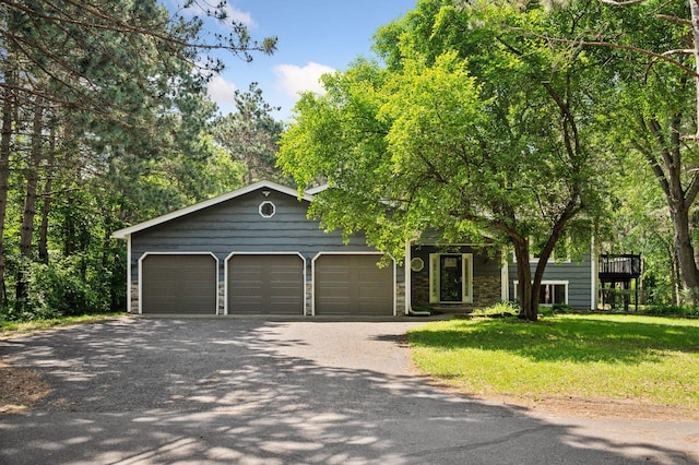 990 221st Ave NW, Oak Grove, MN 55011 - view of front of house with gravel driveway, a front yard, and an attached garage