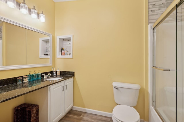 990 221st Ave NW, Oak Grove, MN 55011 - bathroom with wood finished floors, vanity, and bath / shower combo with glass door