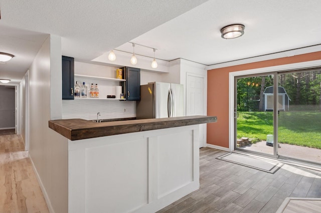 990 221st Ave NW, Oak Grove, MN 55011 - kitchen with freestanding refrigerator, butcher block counters, light wood-style flooring, track lighting, and open shelves
